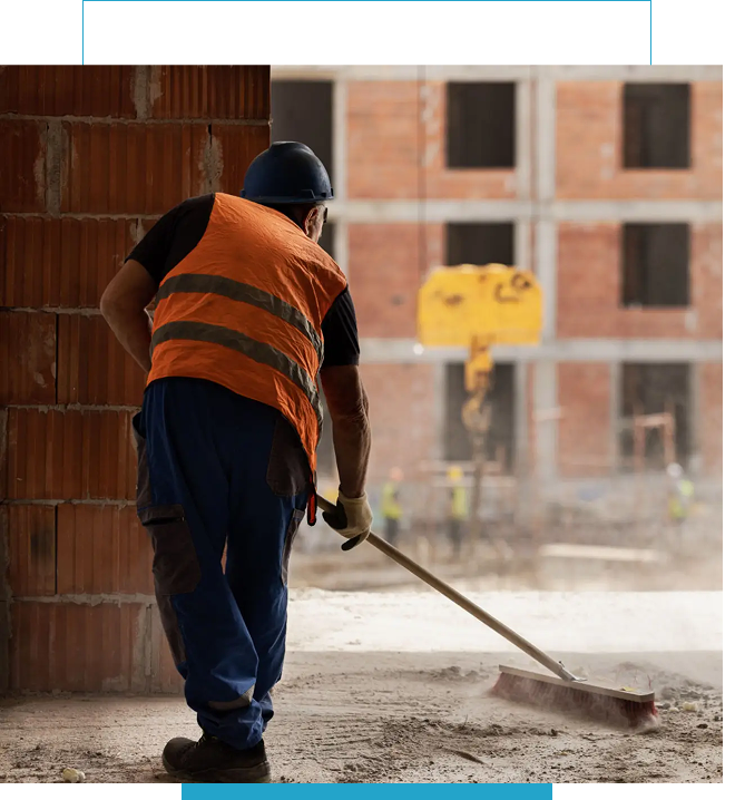 Construction worker smoothing concrete floor indoors.